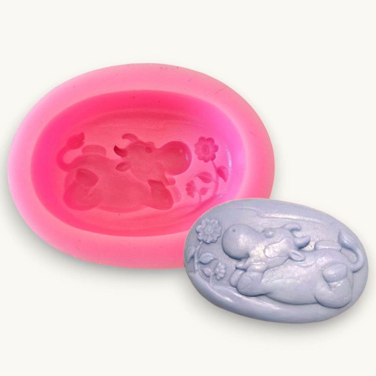 A single cavity silicone mould with a fun cow lying down and a flower. For melt & pour soap or resin 